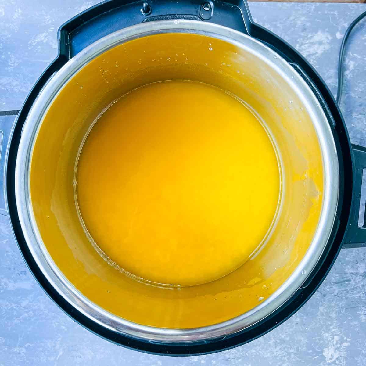 Toor dal, water and turmeric in Instant Pot.