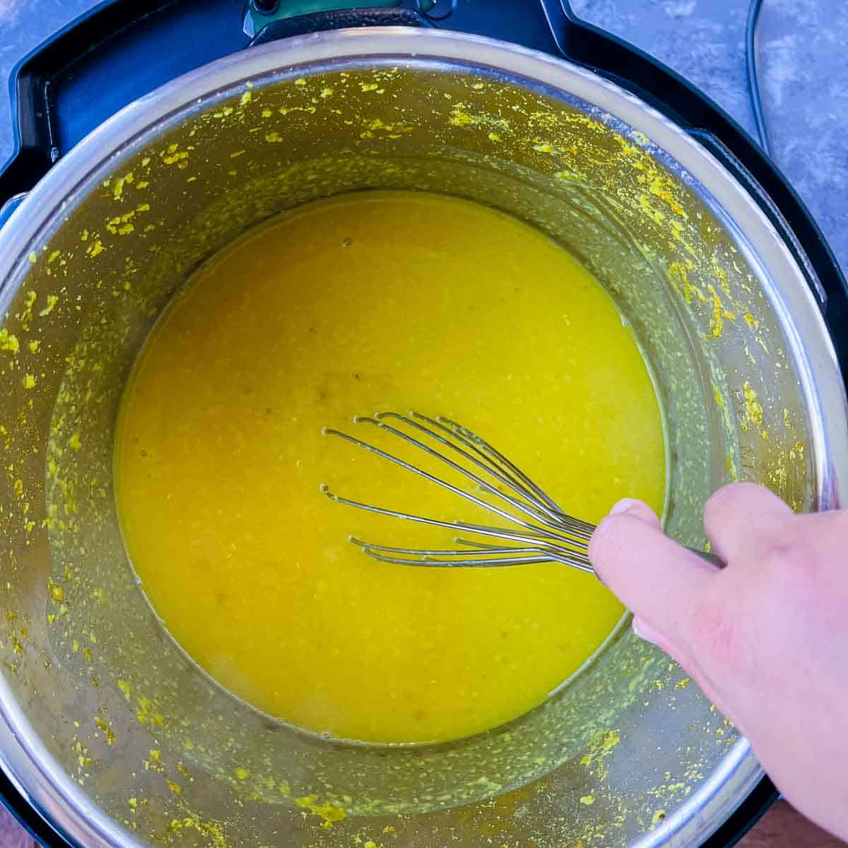 Whisking cooked dal.