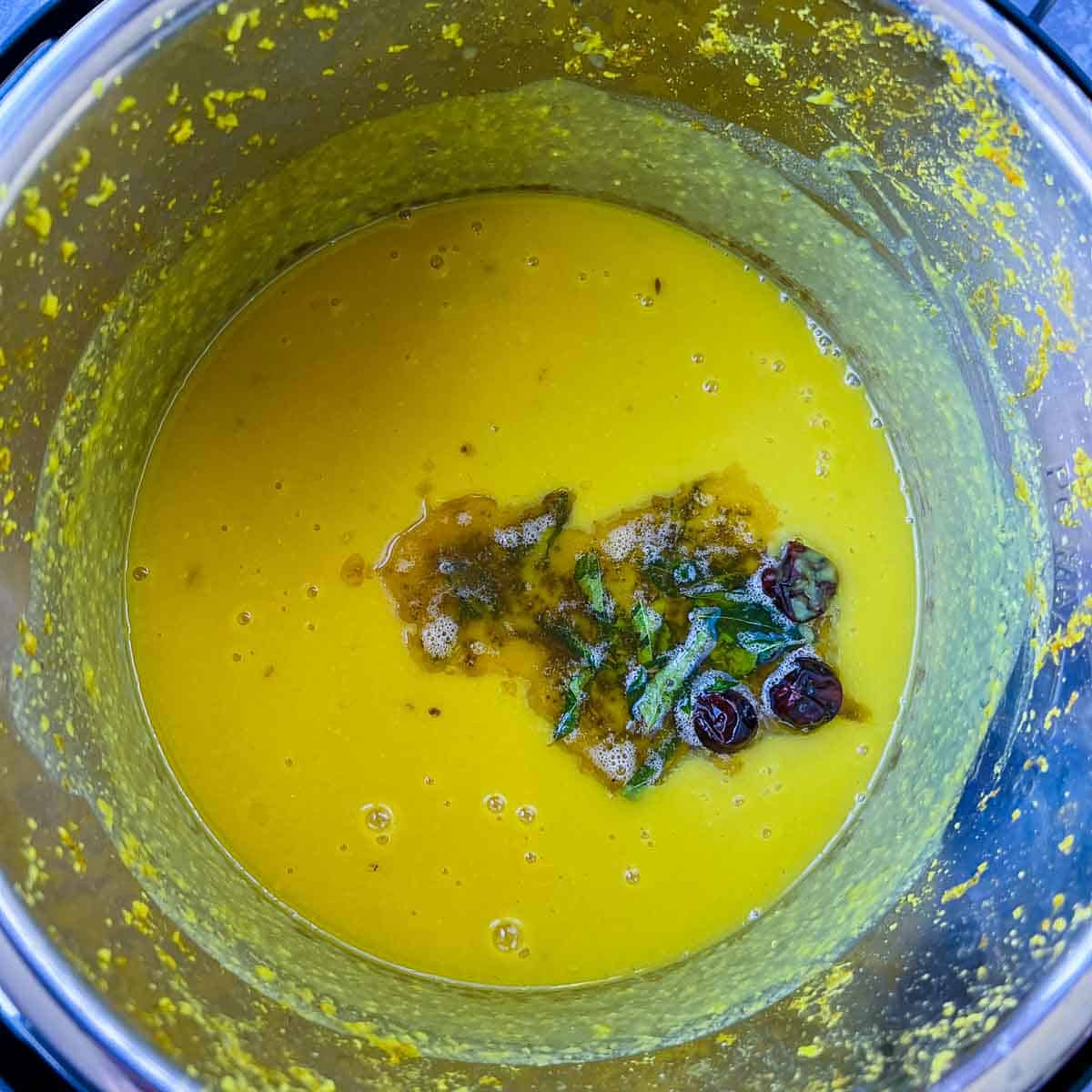 Tempering poured on cooked dal in the Instant Pot.