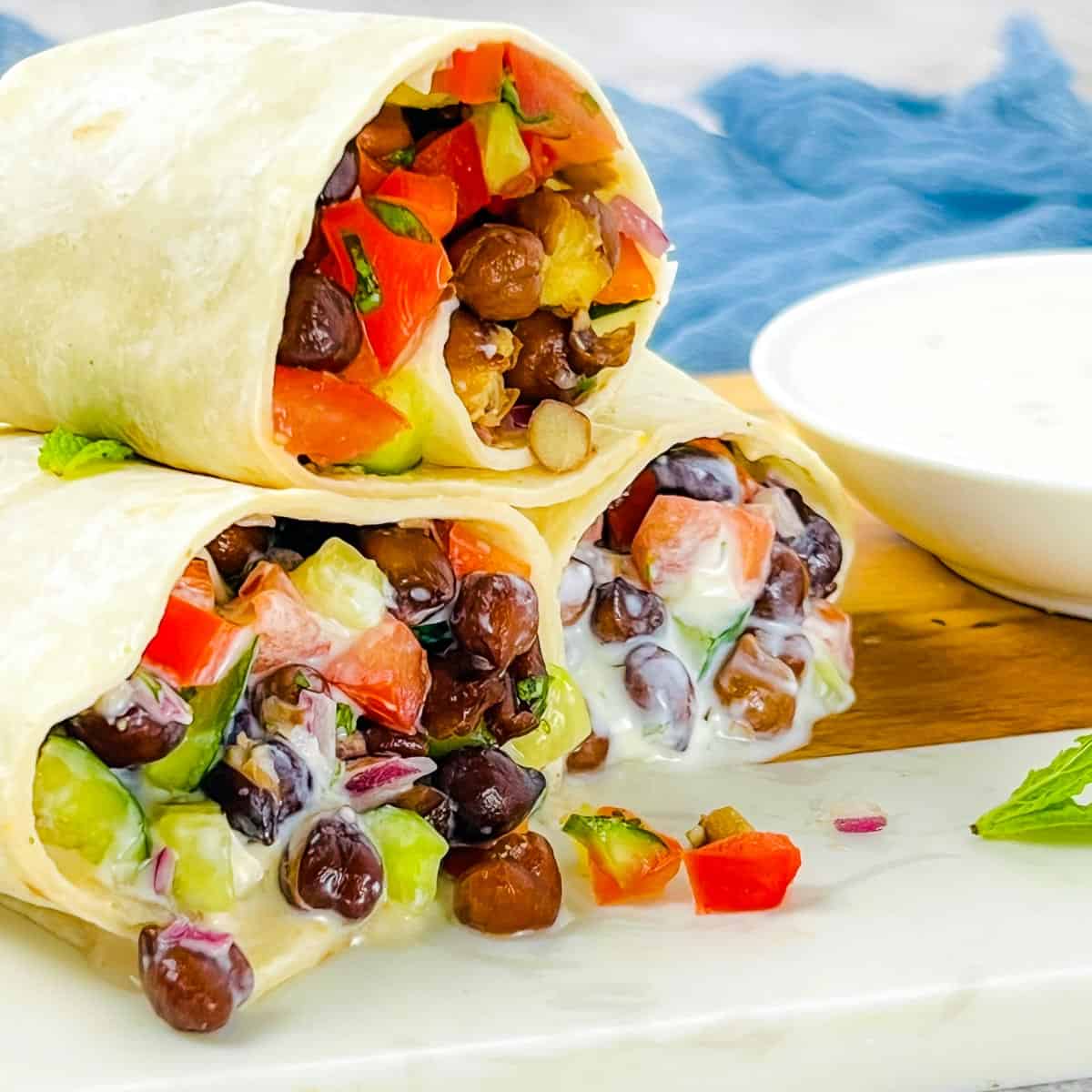 Black chickpea wraps with yogurt sauce.