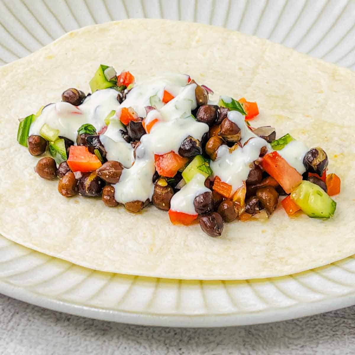Yogurt sauce drizzled on top of the filling.