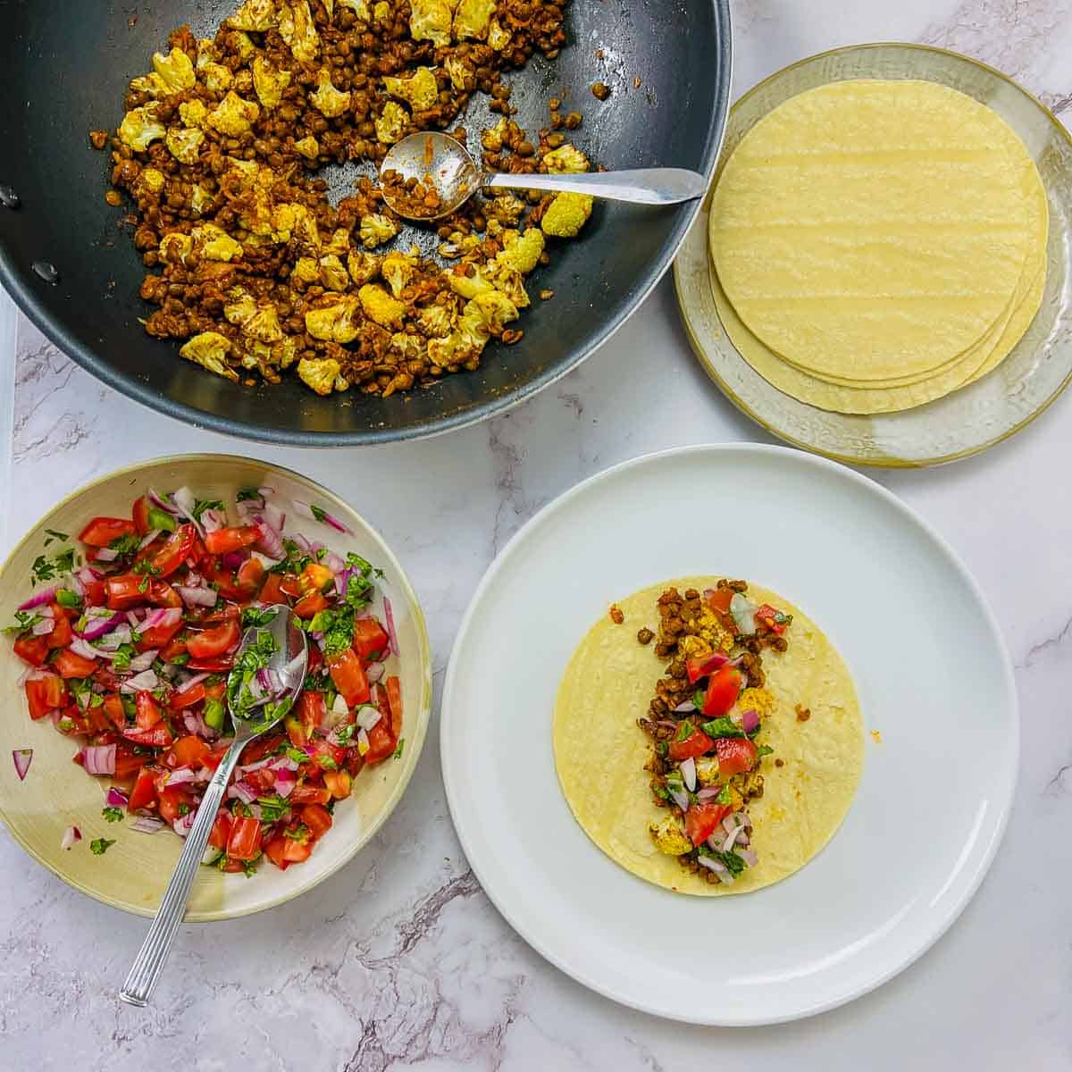Image showing the tacos being assembled.