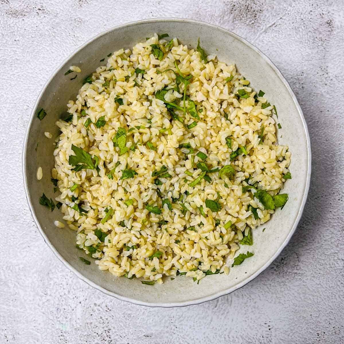 Cilantro lime brown rice in a white bowl.