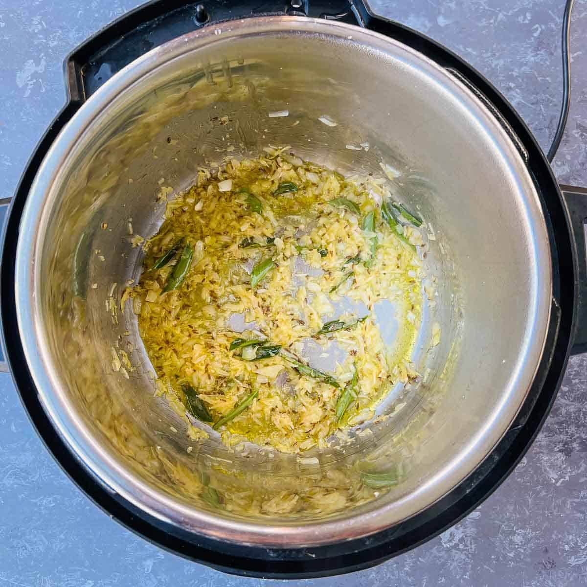 Sauted onion, ginger, garlic, and curry leaves in the Instant Pot.