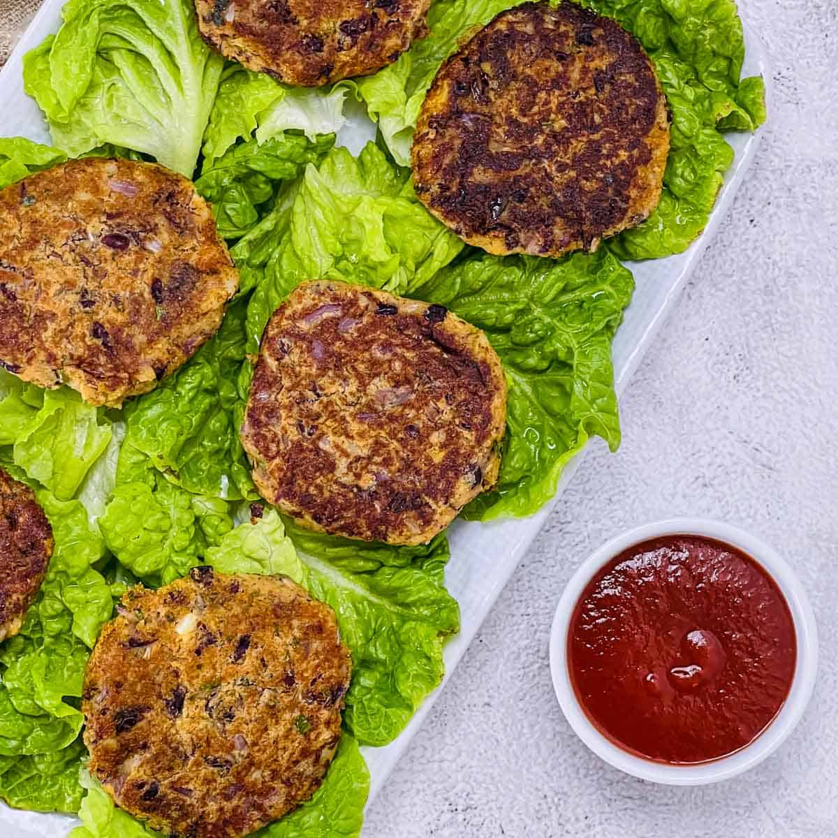 Kidney bean patties on a white plate.