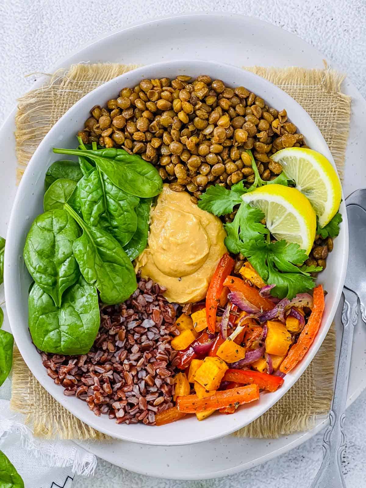 All the elements of lentil buddha bowl assembled for serving.