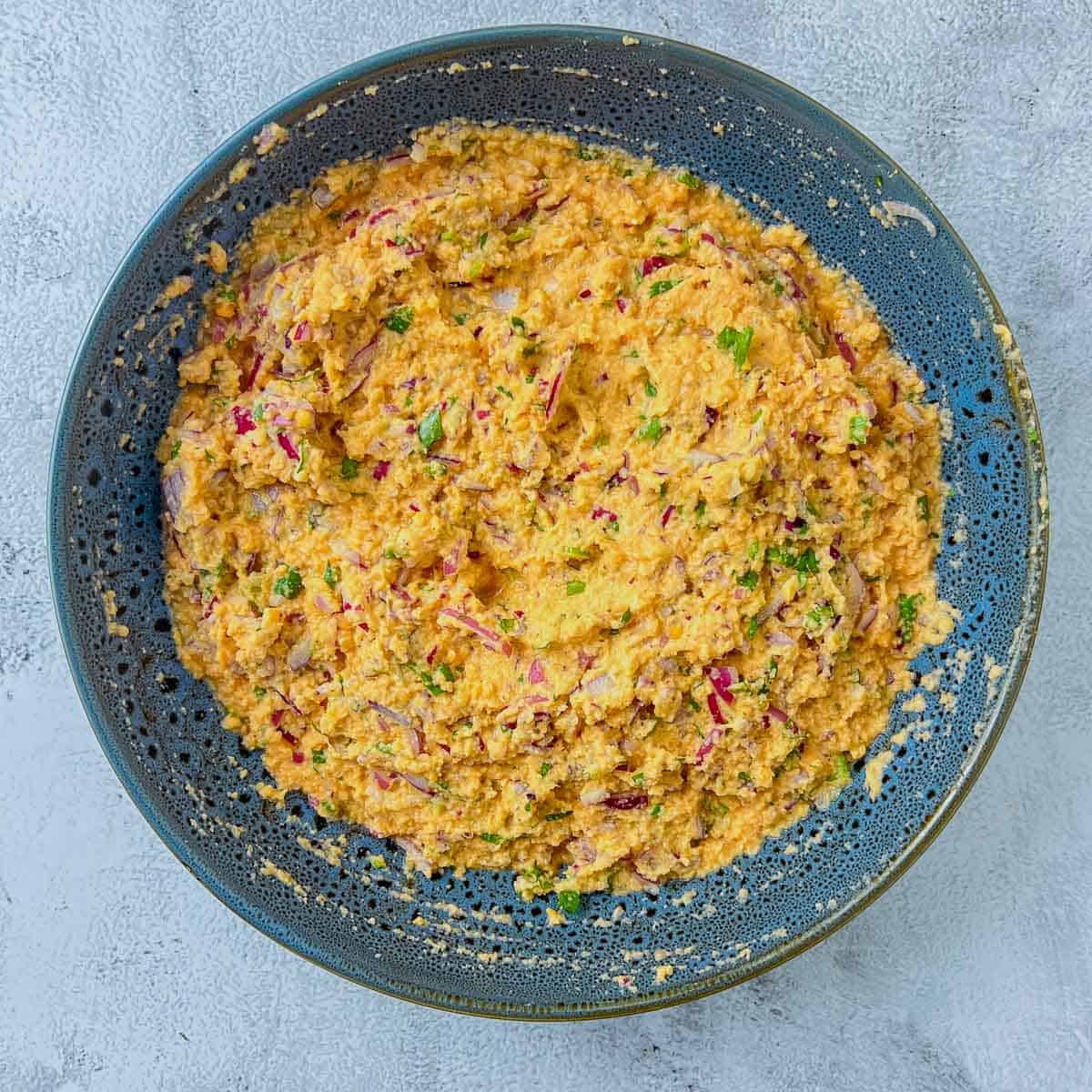 Mixed batter in a grey bowl.