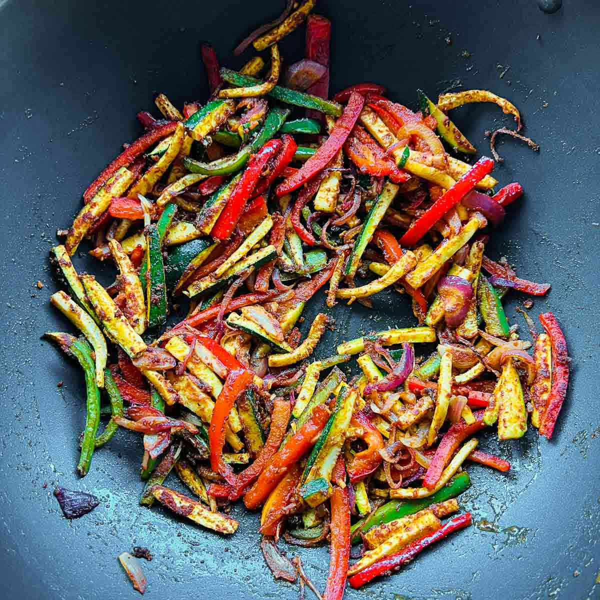 Sauted vegetables and seasoning in the skillet.