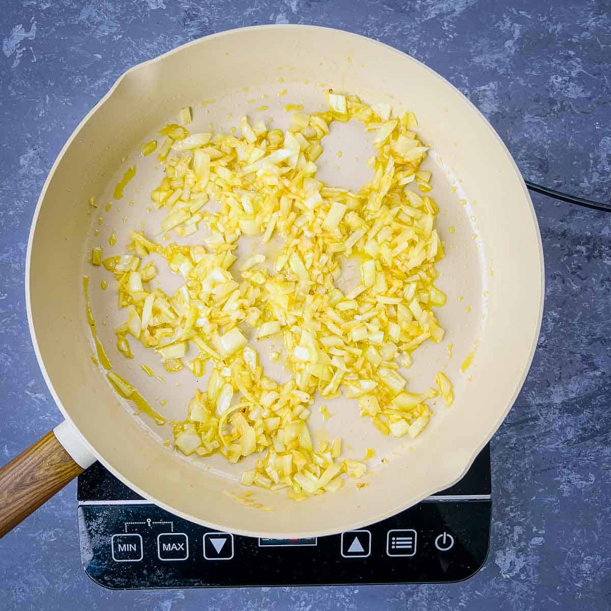 Sauteed onion, ginger, and garlic in the frying pan.