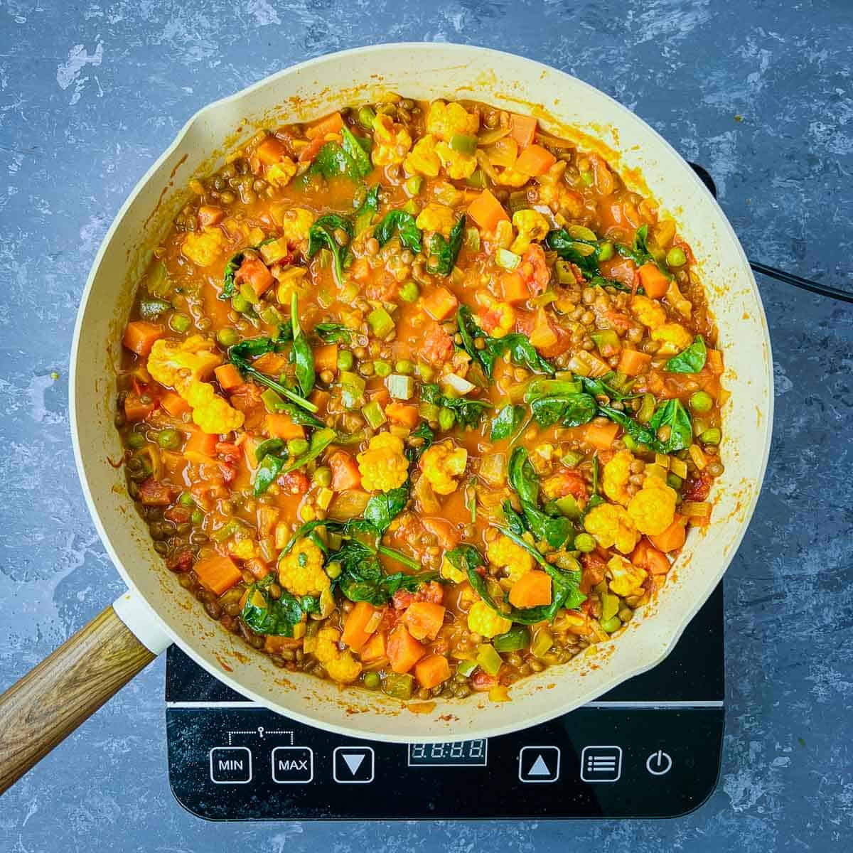 Spinach cooked in the curry in frying pan.