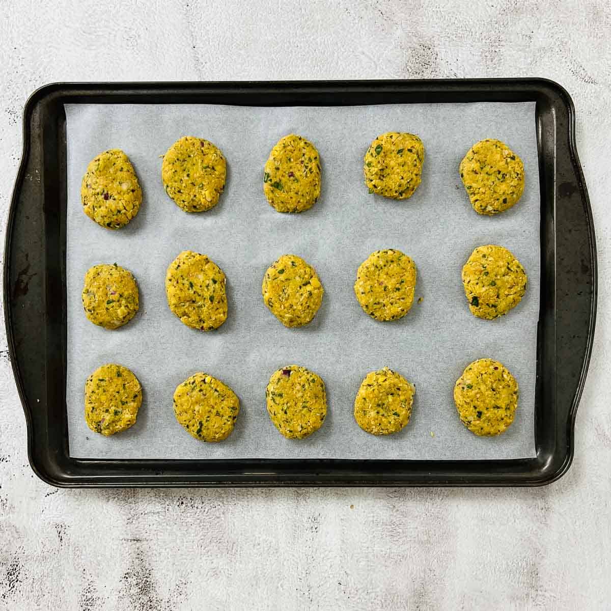 Shaped nuggets on a baking sheet before baking.