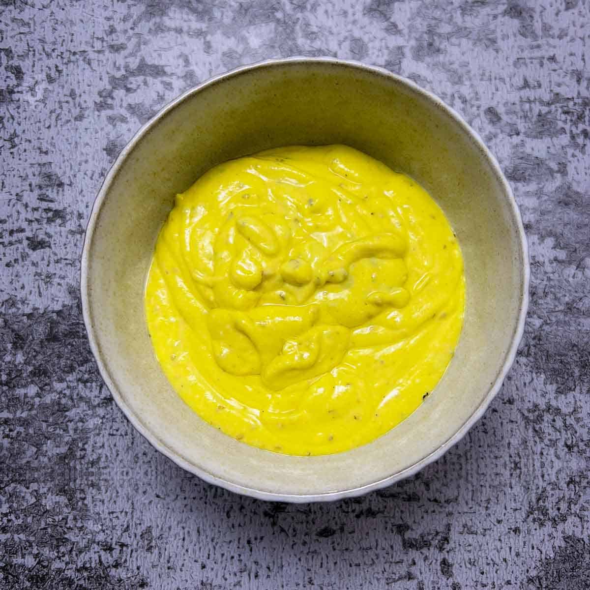 Salad dressing in a small bowl.