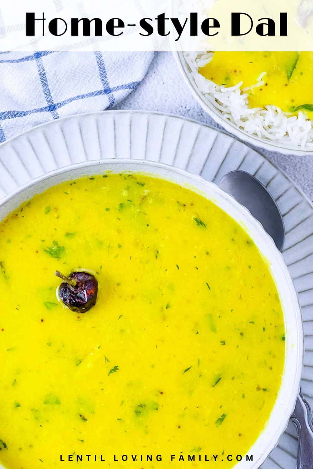 Creamy home-style dal in a white bowl with rice in the background.