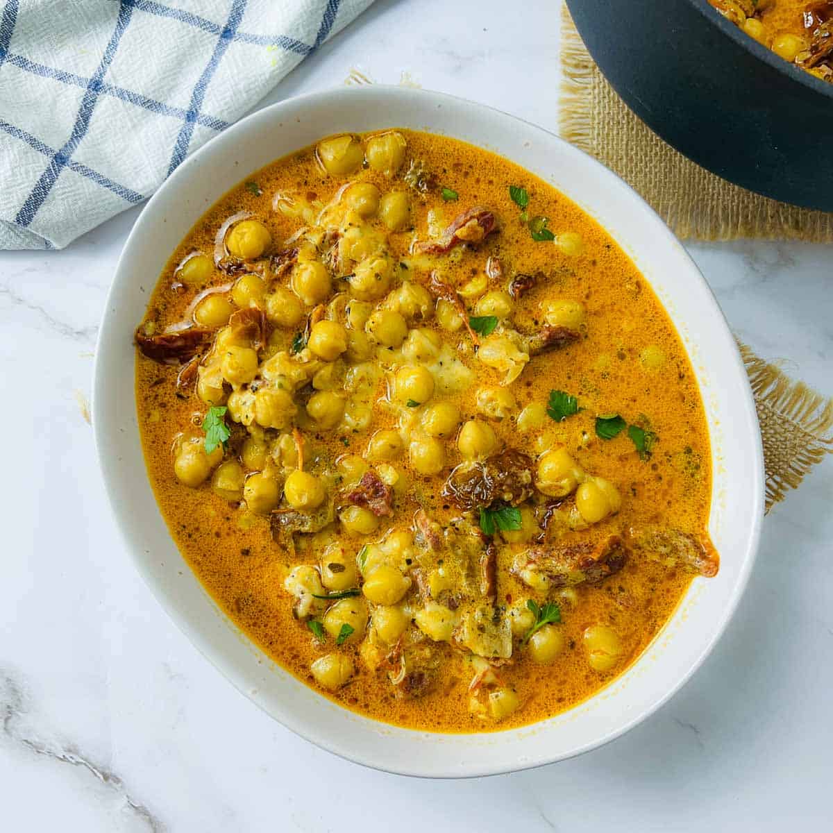 Marry me chickpeas garnished with parsley.