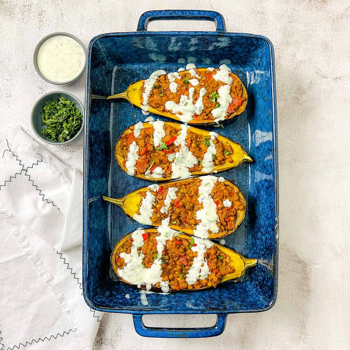Moroccan lentil stuffed eggplant drizzled with yogurt sauce.
