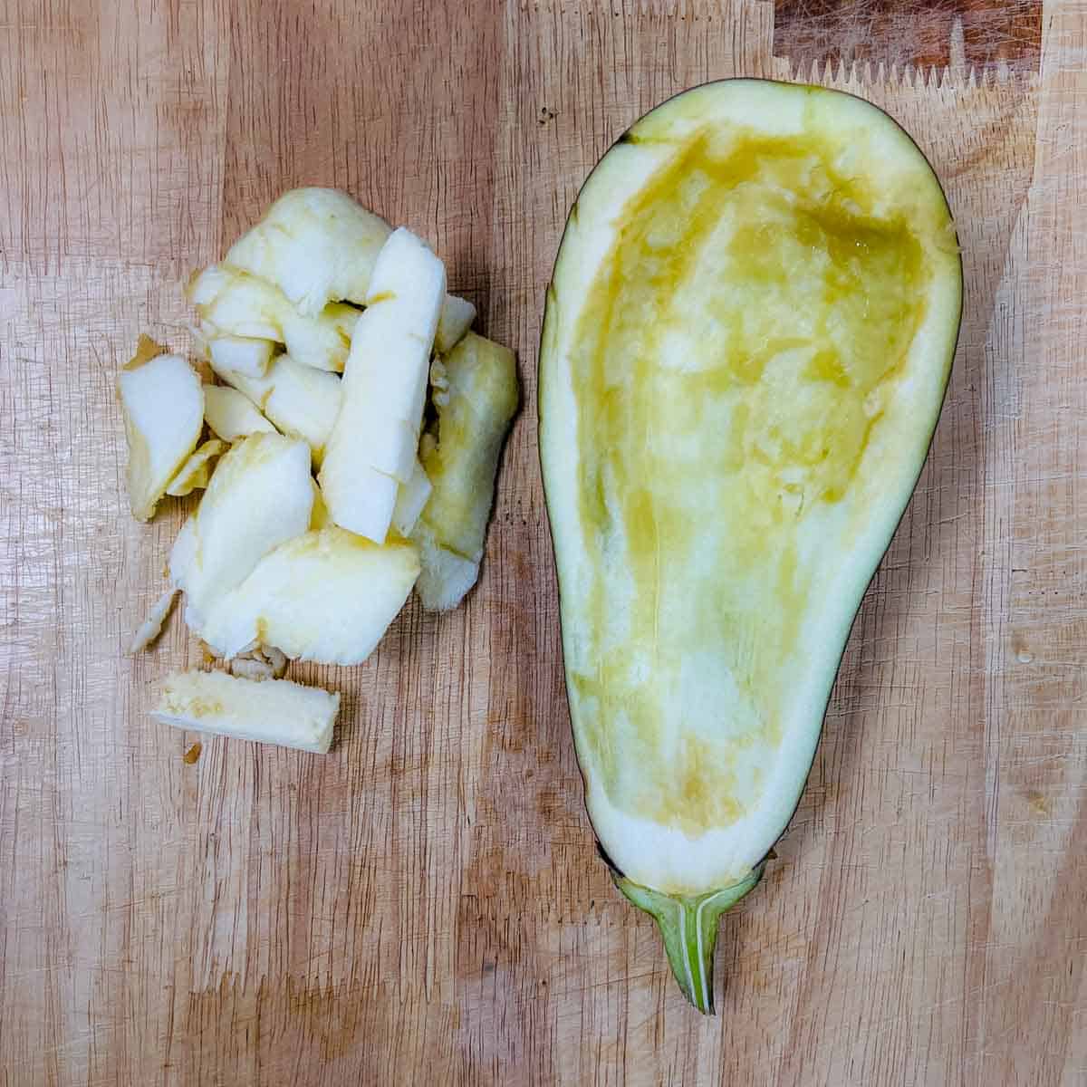 Eggplant cut lengthwise and flesh scooped out.