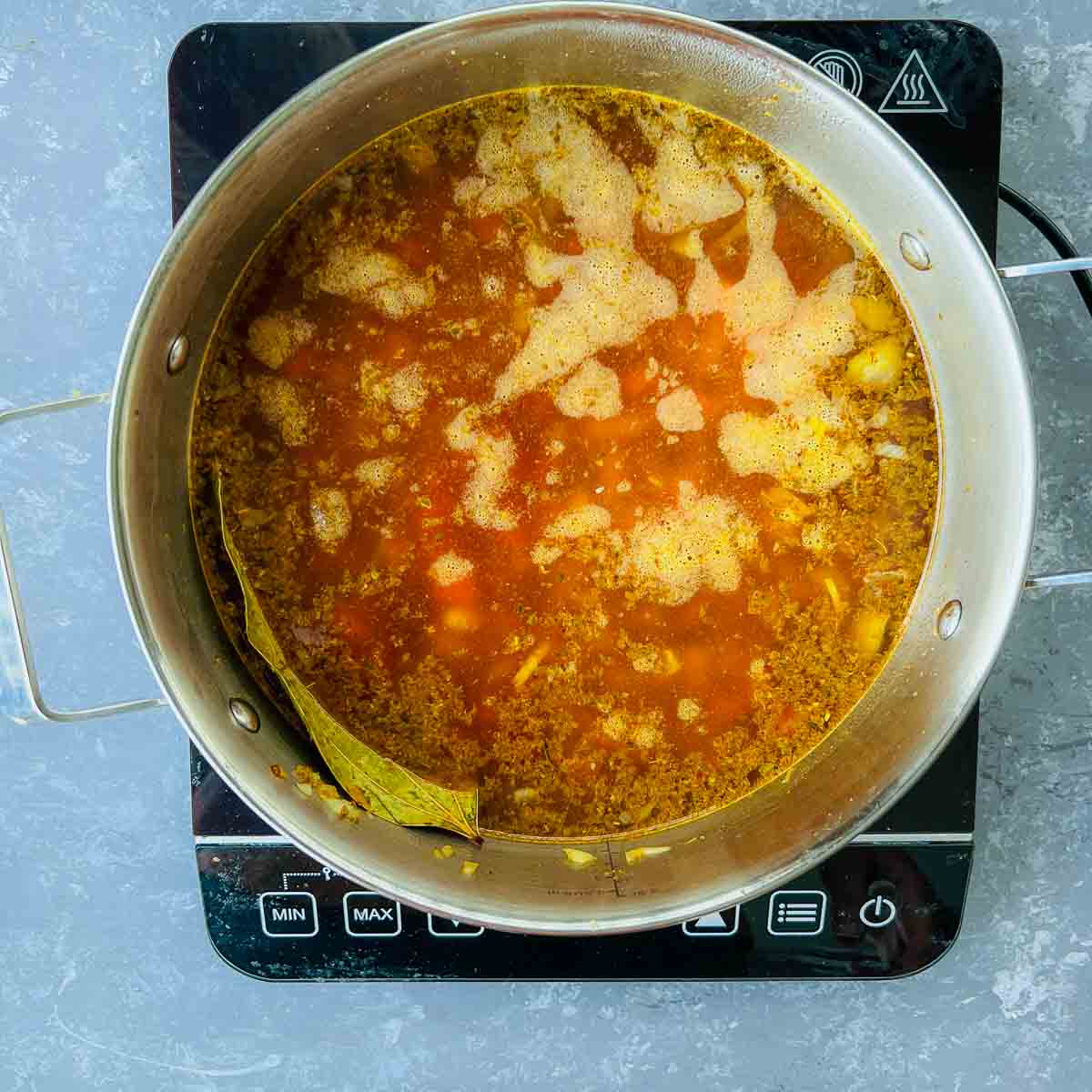White beans, spices, and stock in the pot.
