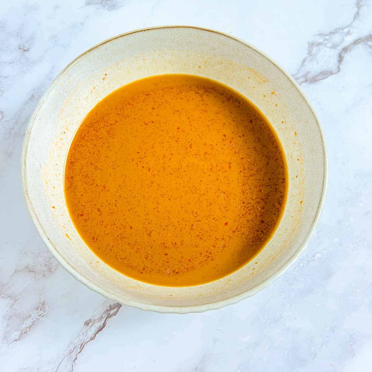 Stir-fry sauce in a small brown bowl.
