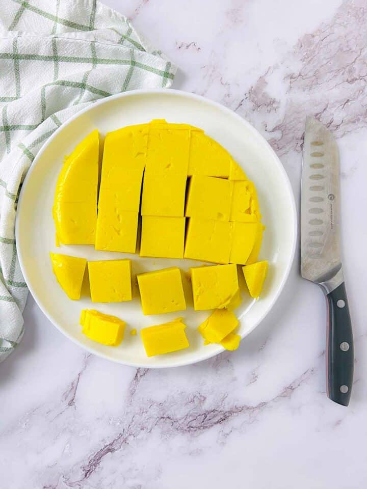 Chickpea tofu cut and placed on a white plate.