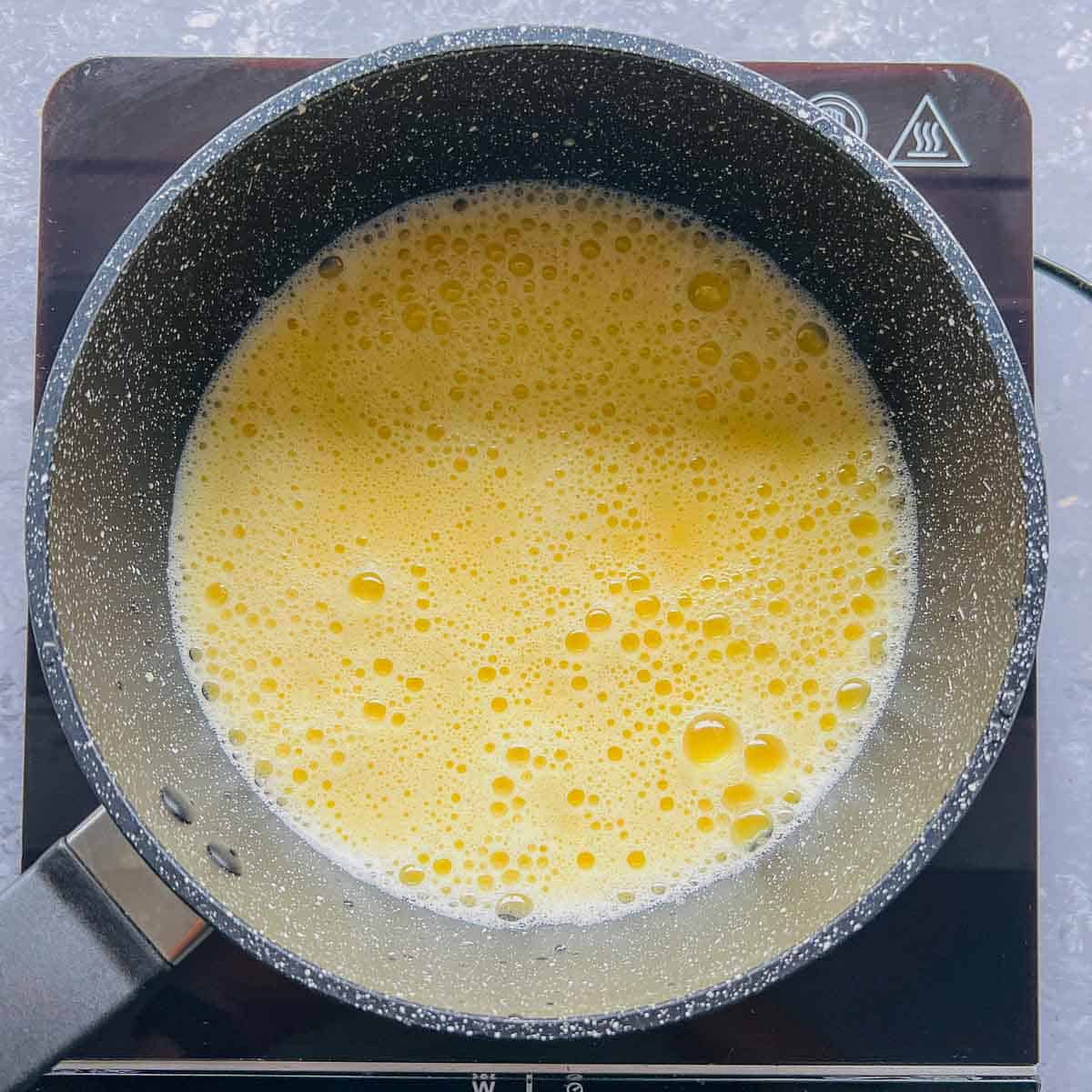 Chickpea flour, water, salt, and turmeric whisked in a saucepan.