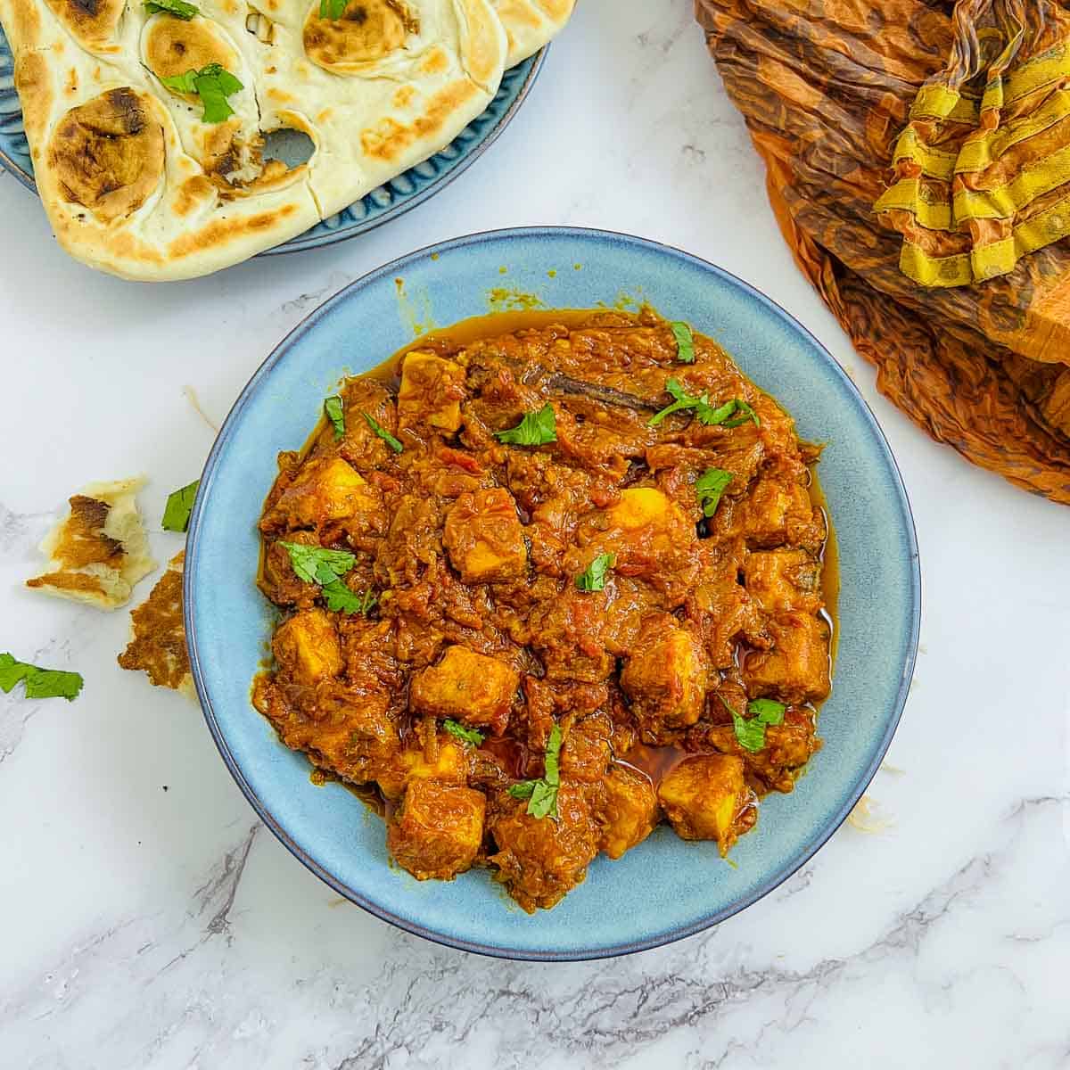 Chickpea tofu tikka masala served with naan bread.
