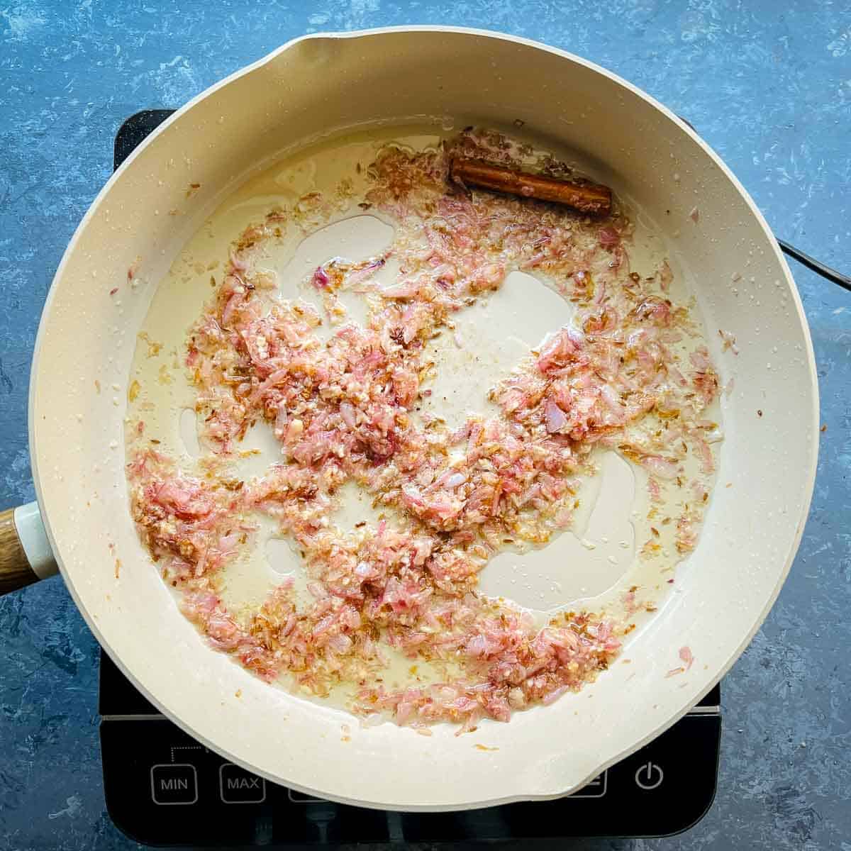 Sauted onion, ginger, and garlic in frying pan.