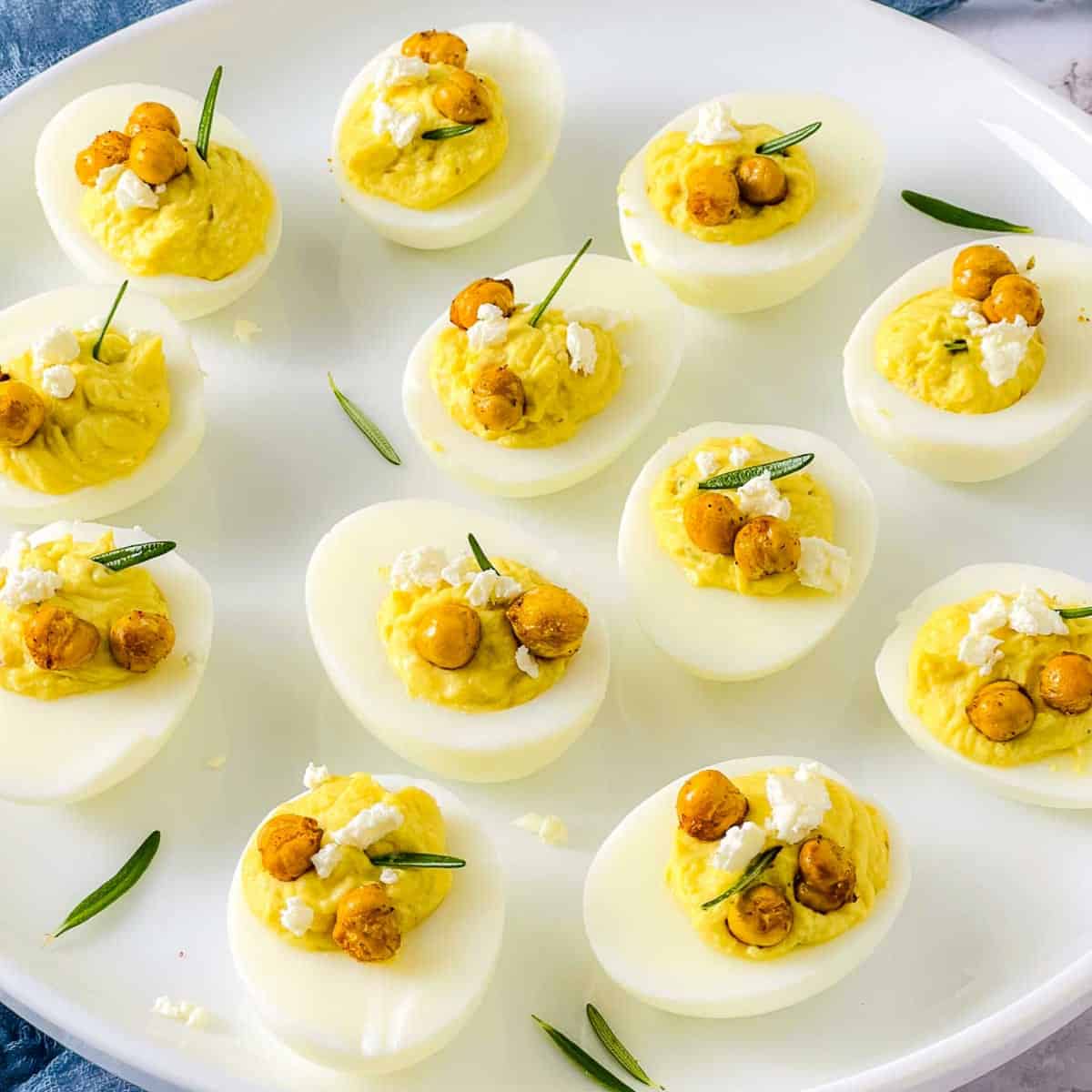 Close up of filled deviled eggs showing the various toppings.