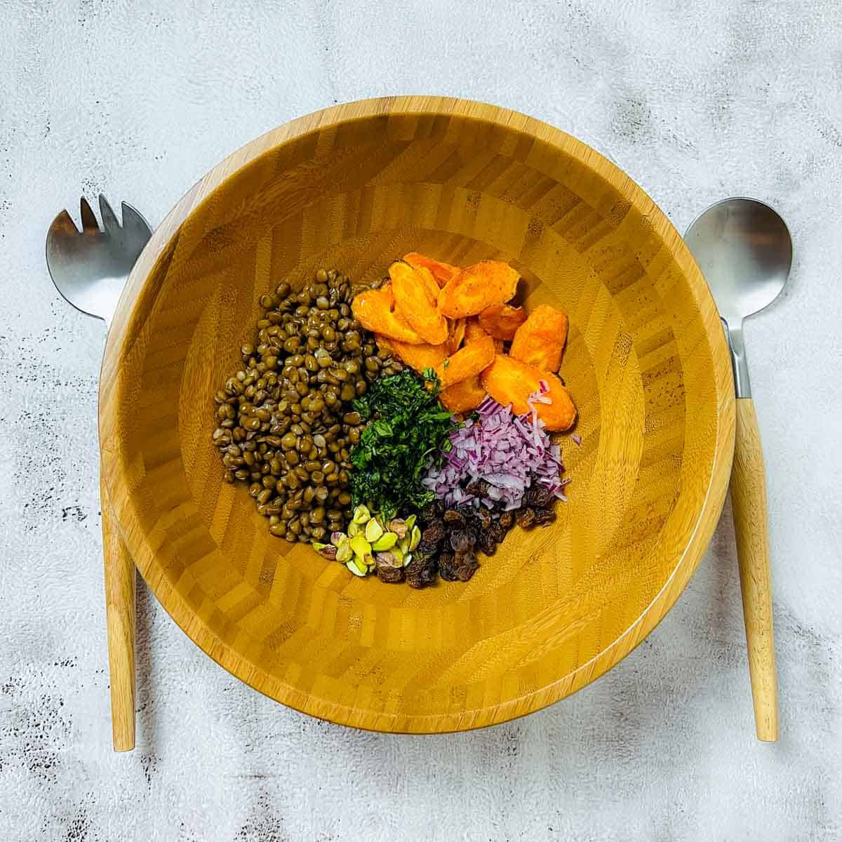 All salad ingredients in a mixing bowl.