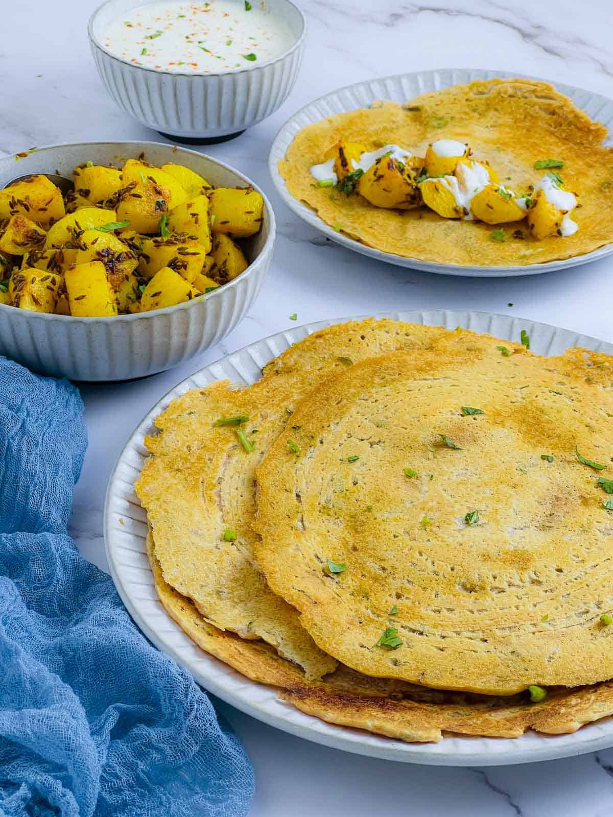 Red lentil pancakes on a white plate.