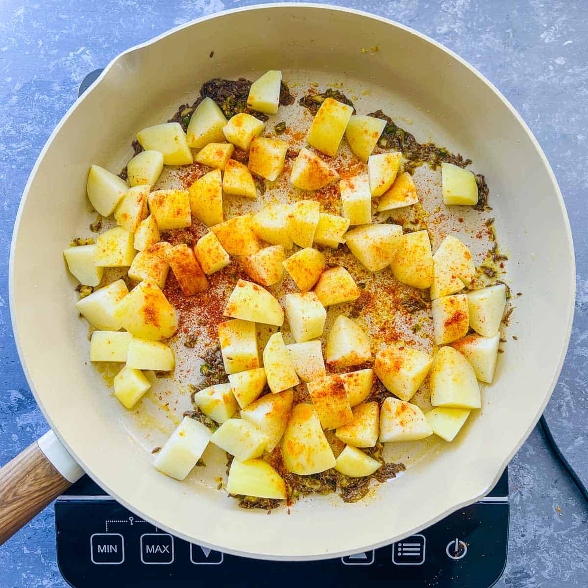 Spices sauted in frying pan.