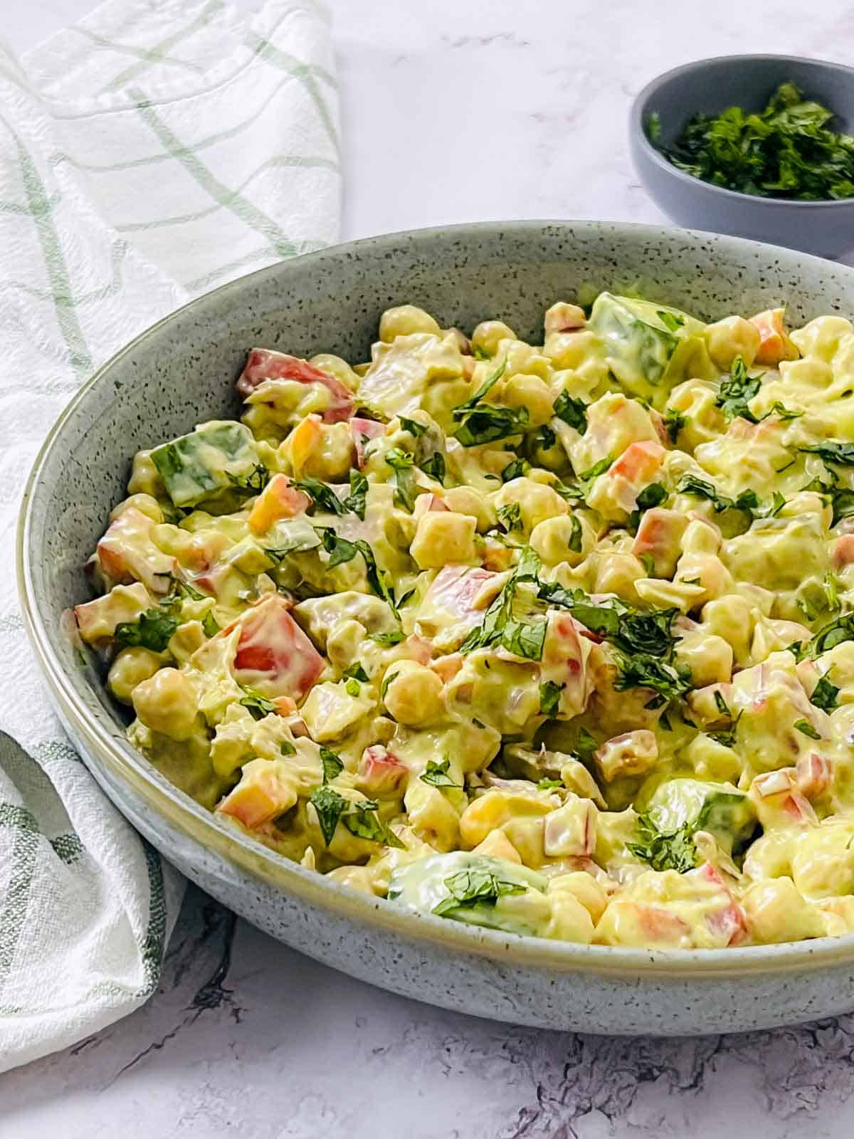 Tuna chickpea salad in a green bowl.