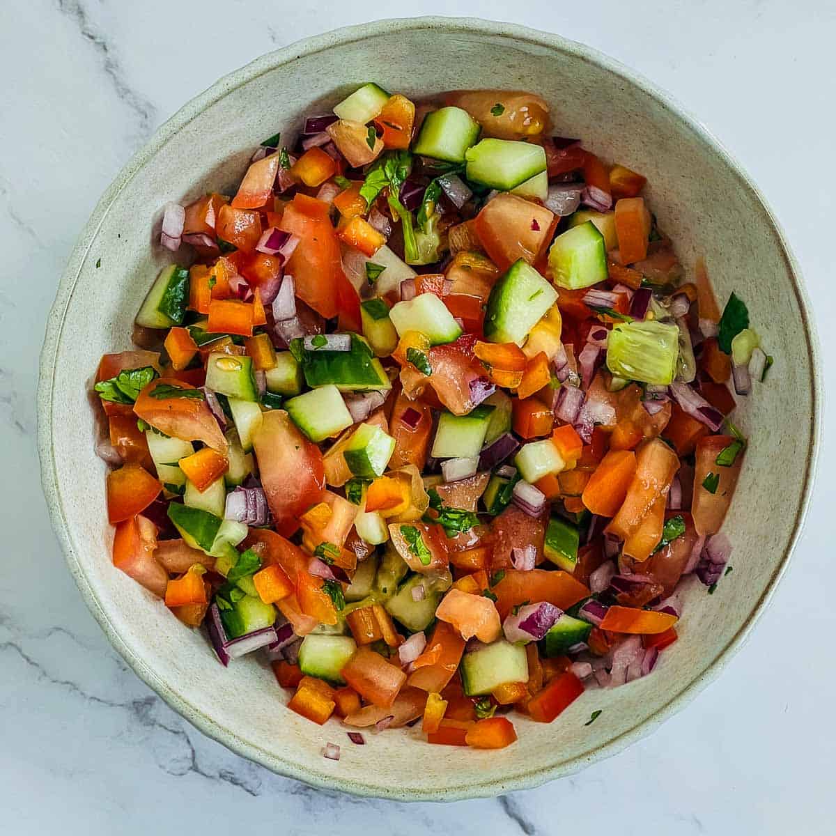 Vegetable salad in a brown bowl.