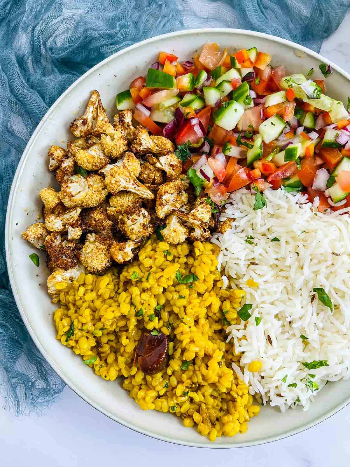 Assembling yellow lentil buddha bowl.