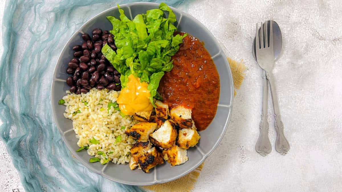 Chicken and black bean burrito bowl with spoon in the background.