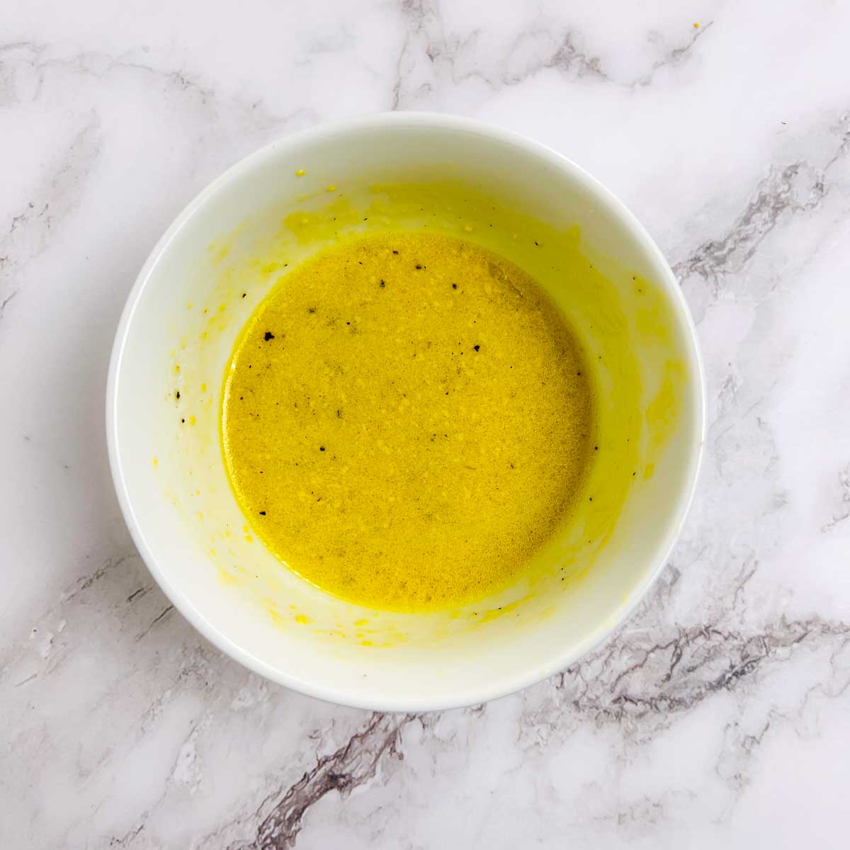 Prepared dressing in a small white bowl.