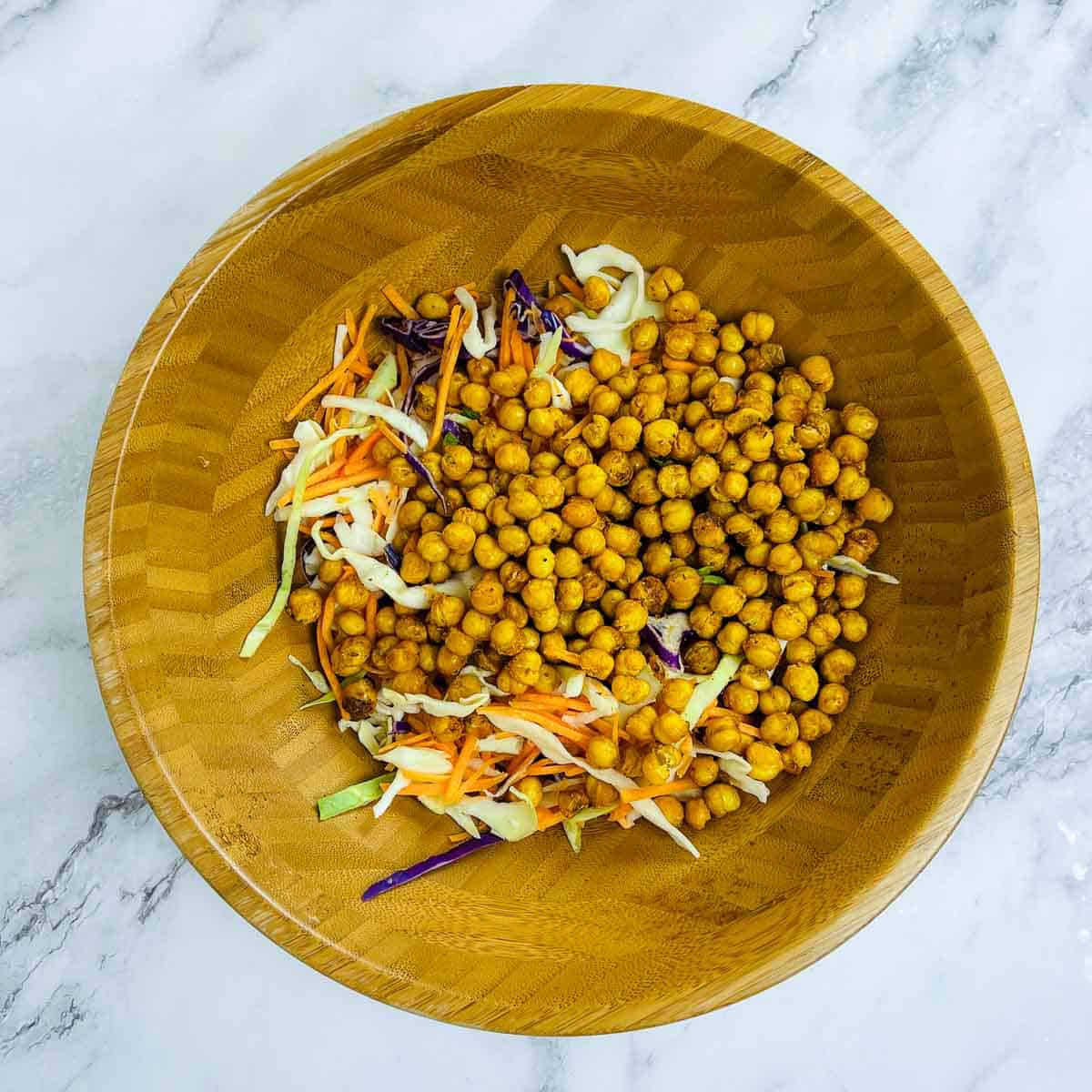 Veggies and roasted chickpeas in the mixing bowl.