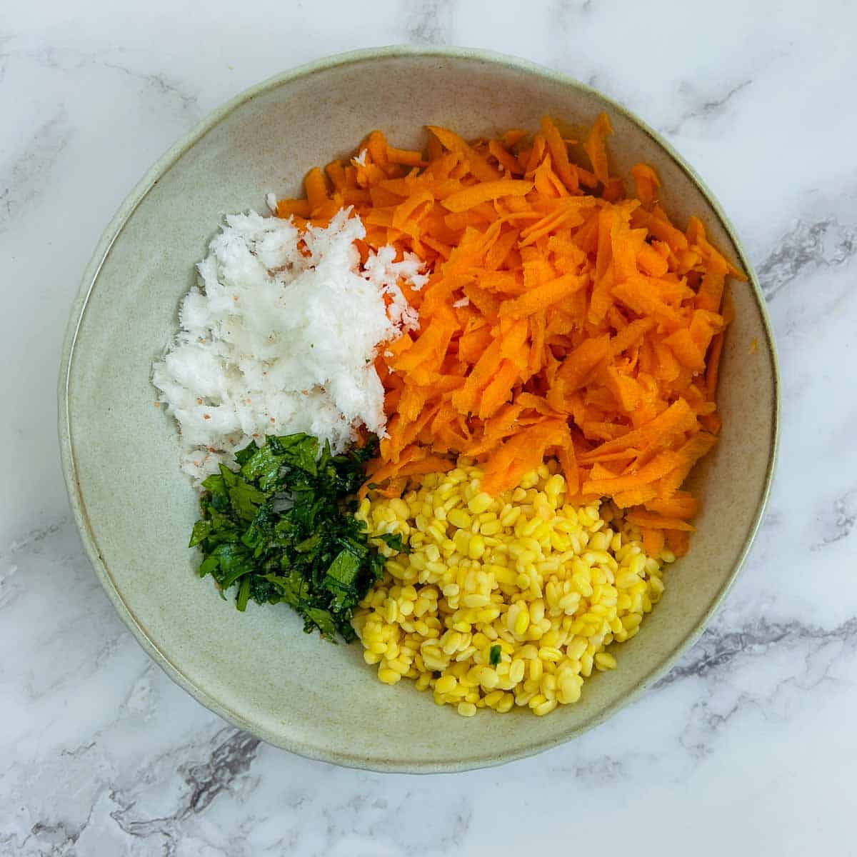 Ingredients to make kosambari in a wide brown bowl.
