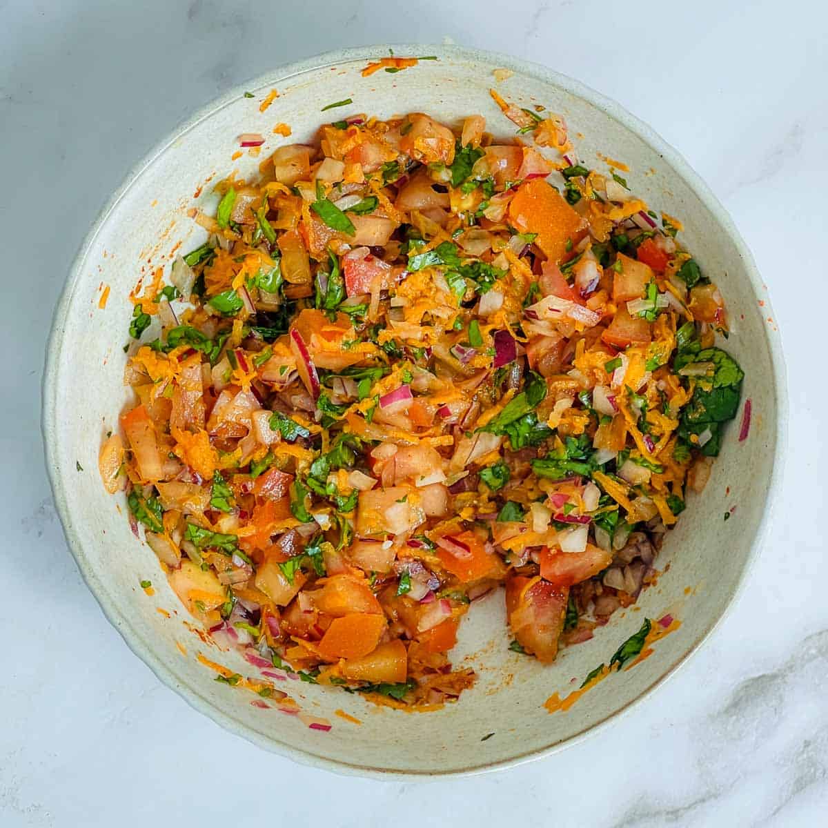 Vegetables and spices mixed in a small bowl.