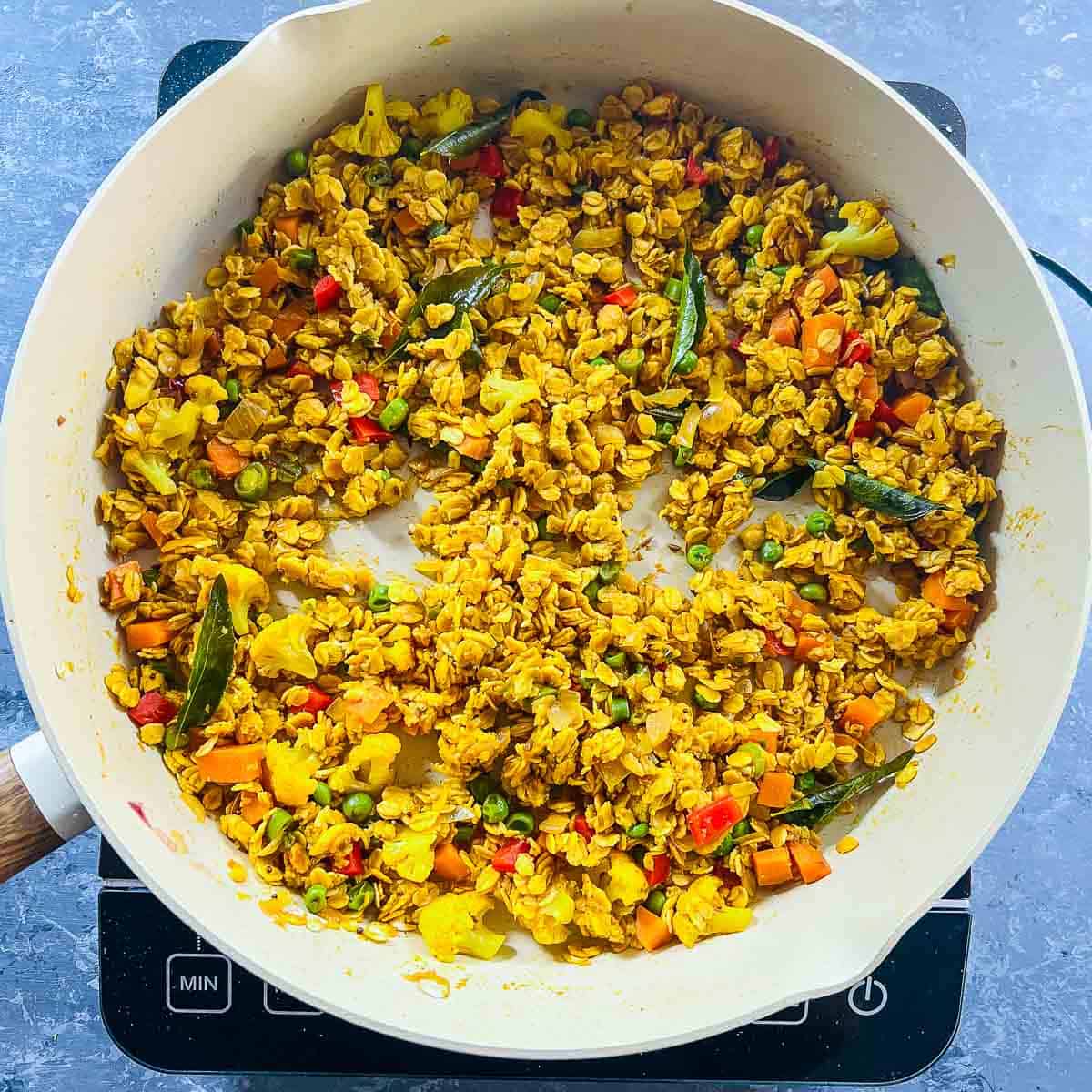 Cooked oats upma in the frying pan.