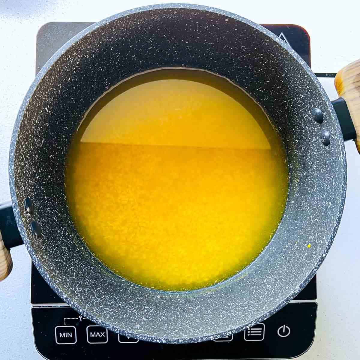 Moong dal, rice, water, and turmeric in the pan.