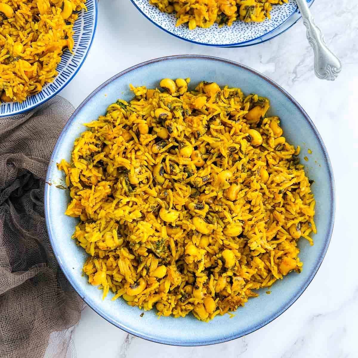 Indian style black eyed-peas and rice in a blue bowl.