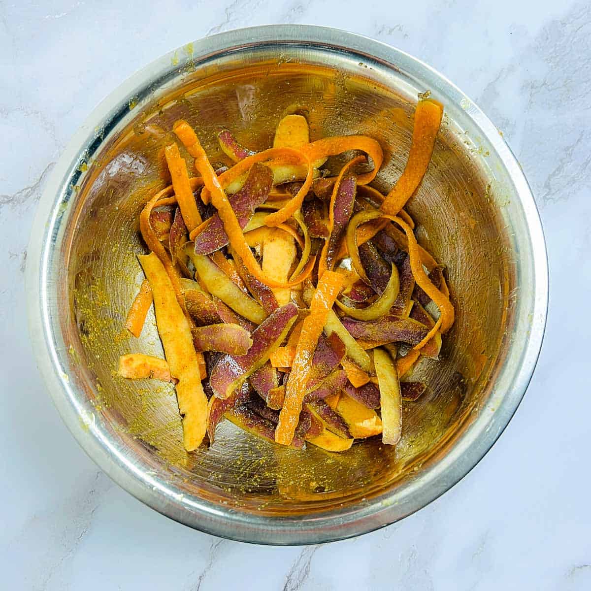 Seasoned peels in a mixing bowl.