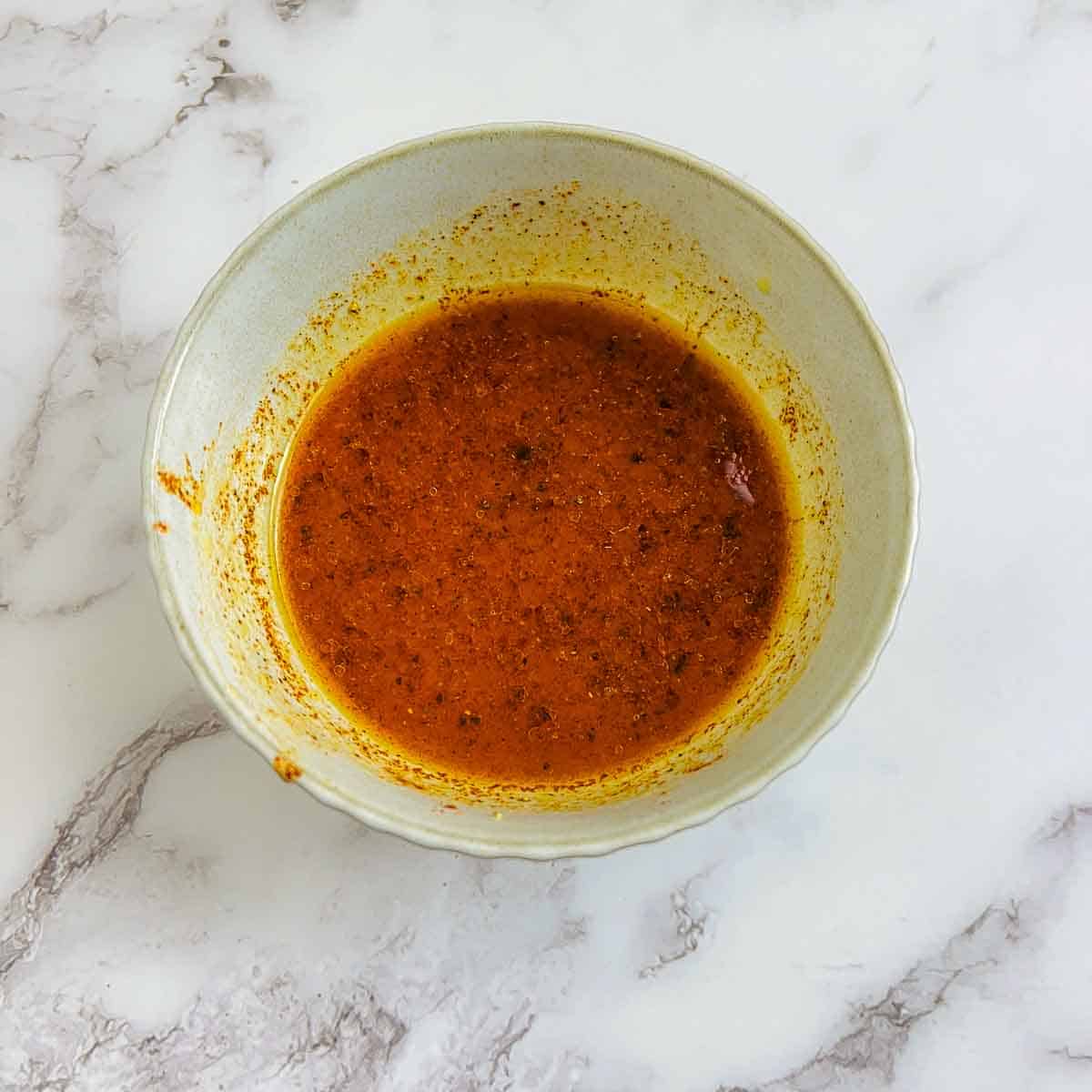 Dressing in a small brown bowl.