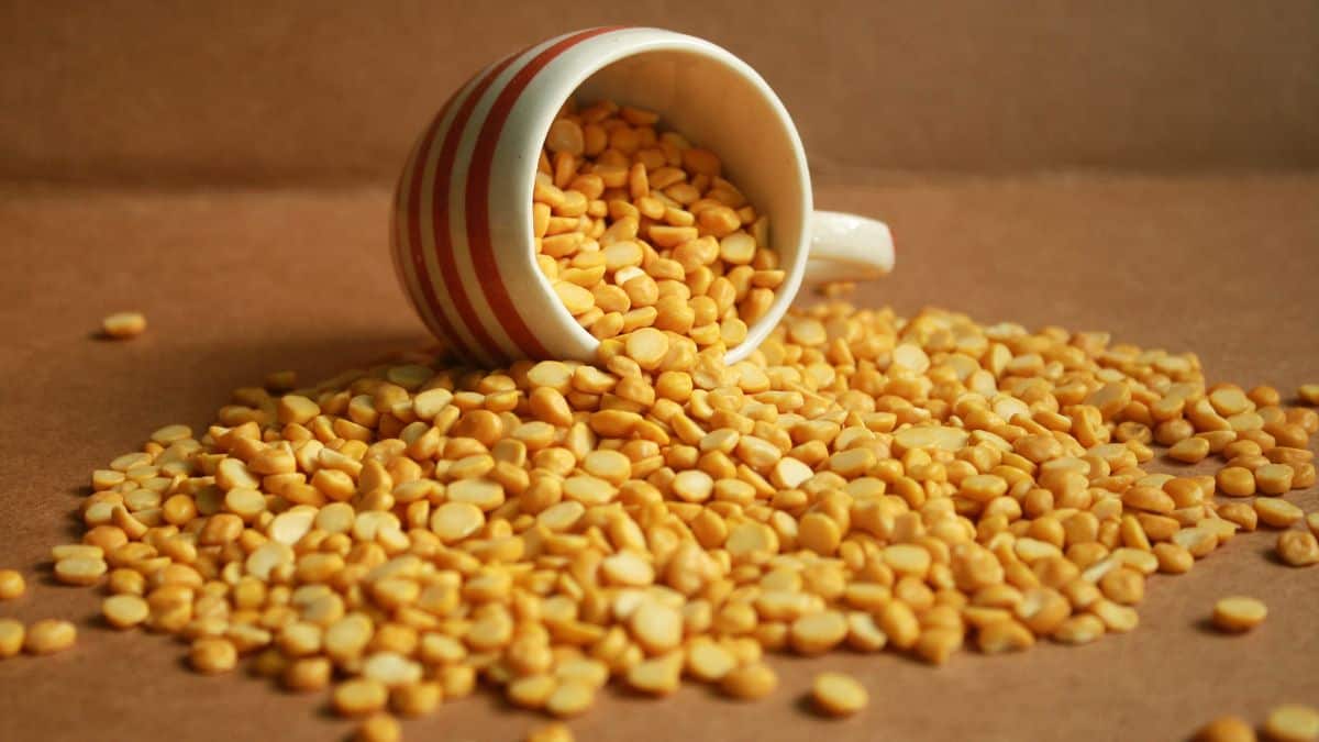 Chana dal on a wooden surface.