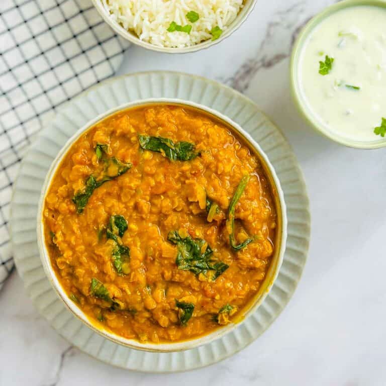 Red lentil dal served with rice and raita.