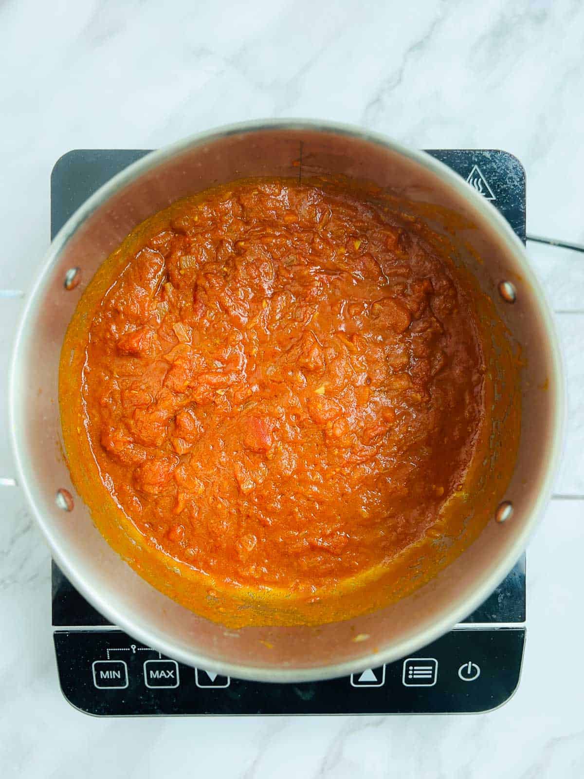 Tomato and spices cooked in the pot.