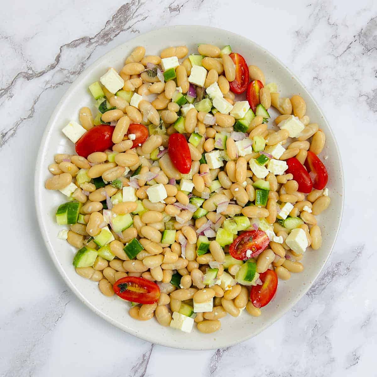 Seasoned veggies on a white serving plate.