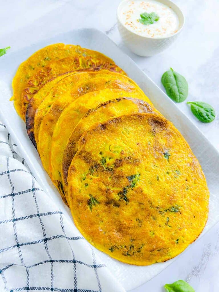 Chickpea flour pancakes on a white plate.