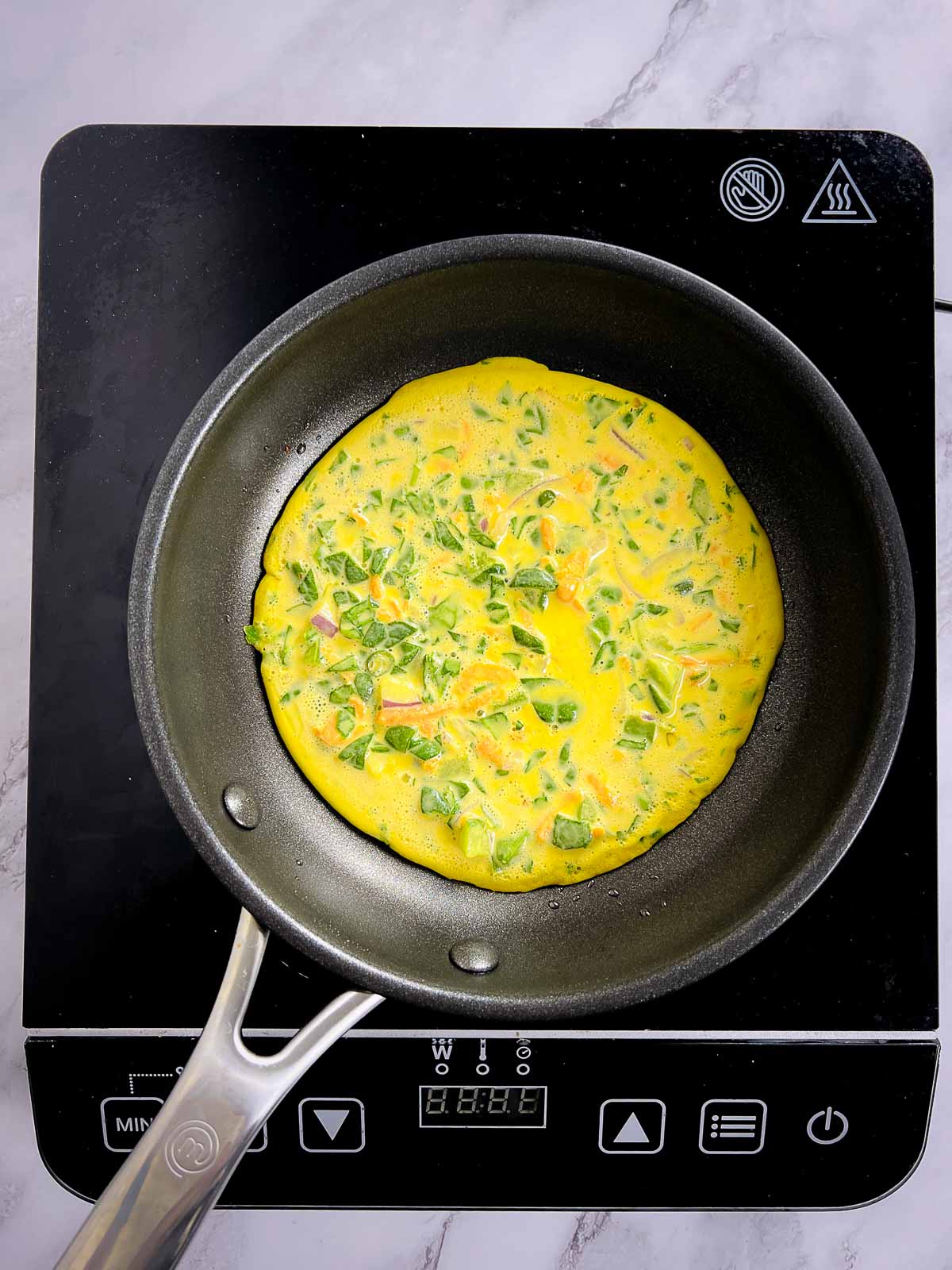 Pour a ladle of batter on a frying pan.