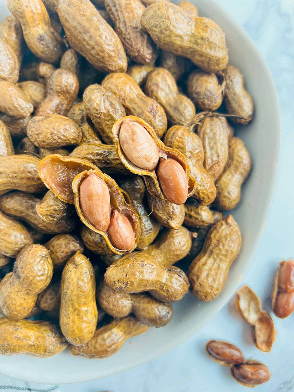 Cooked unshelled peanut with shell open.